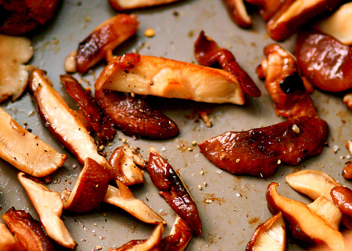 Sauteeing shiitake mushrooms in a non-stick skillet until golden brown.