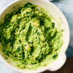Best vegan guacamole in a serving bowl with cilantro.