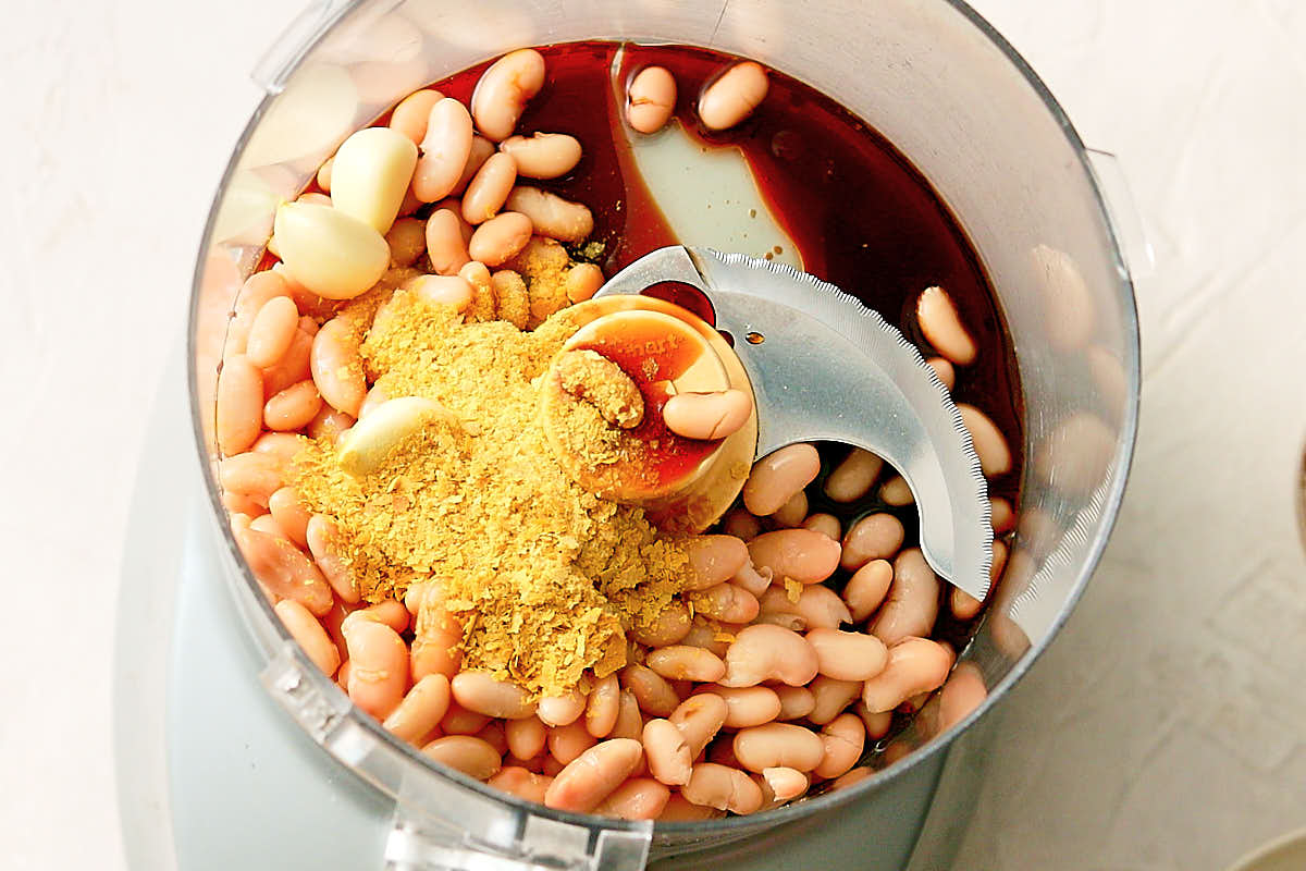 Beans and seasonings in a food processor to make vegan seitan.