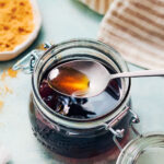 Easy brown sugar simple syrup in a glass jar with a spoon.