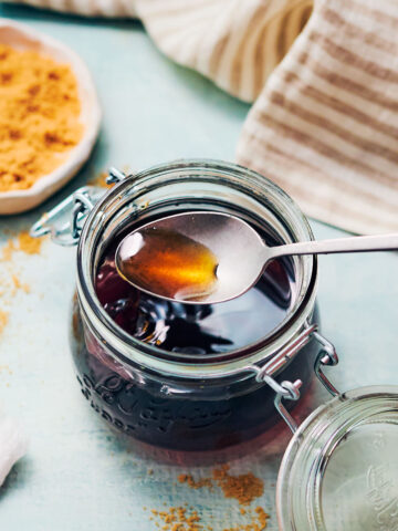 Easy brown sugar simple syrup in a glass jar with a spoon.
