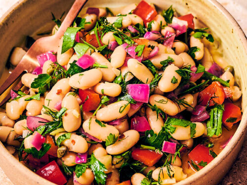 Tuscan bean salad with dill and bell peppers in a bowl.