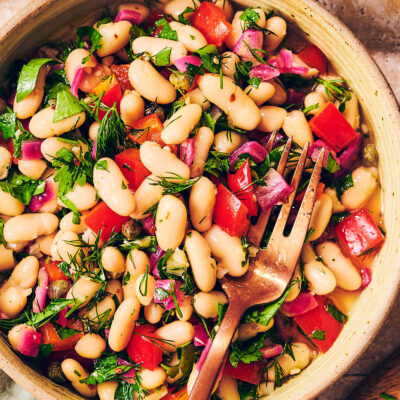 A bowl of easy Cannellini Bean Salad with a fork.