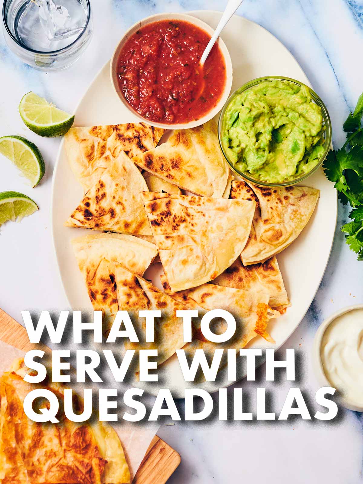 Quesadillas on a serving plate with salsa and guacamole.
