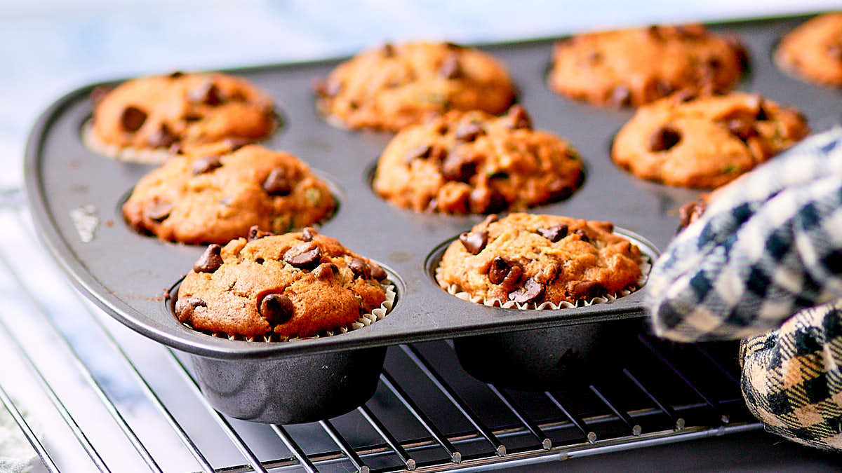 Easy Vegan Zucchini Muffins with chocolate in a baking tin.
