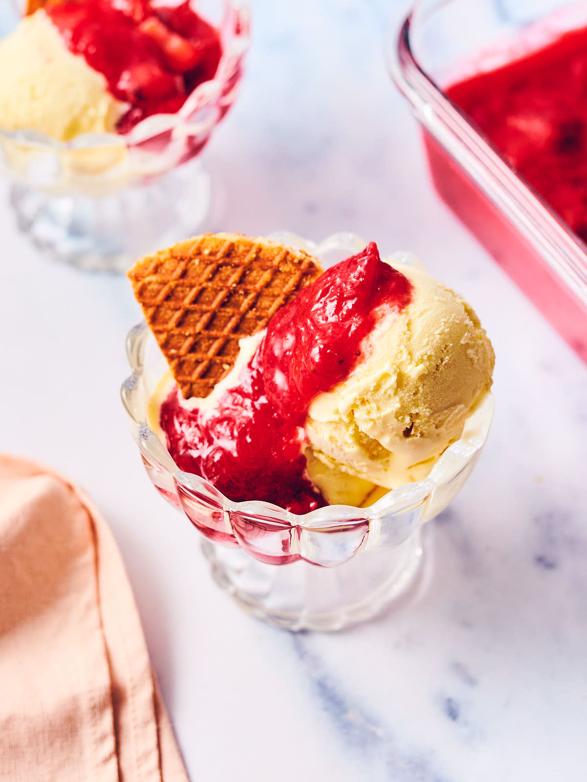 Ice cream topped with rhubarb compote and a stroopwafel.