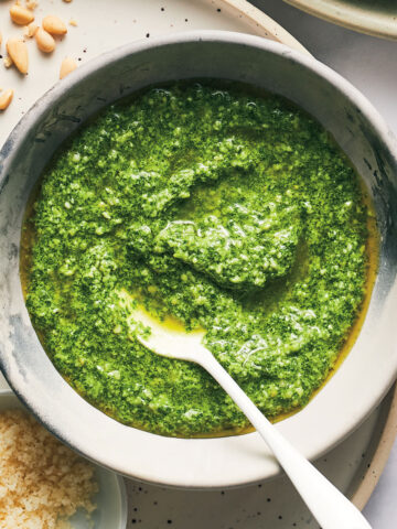 Pesto Salad Dressing in a bowl with a spoon.