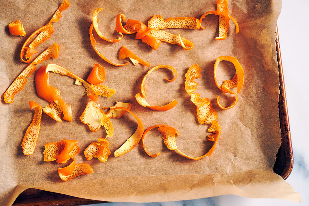Orange rind (peel) on a parchment lined baking sheet.