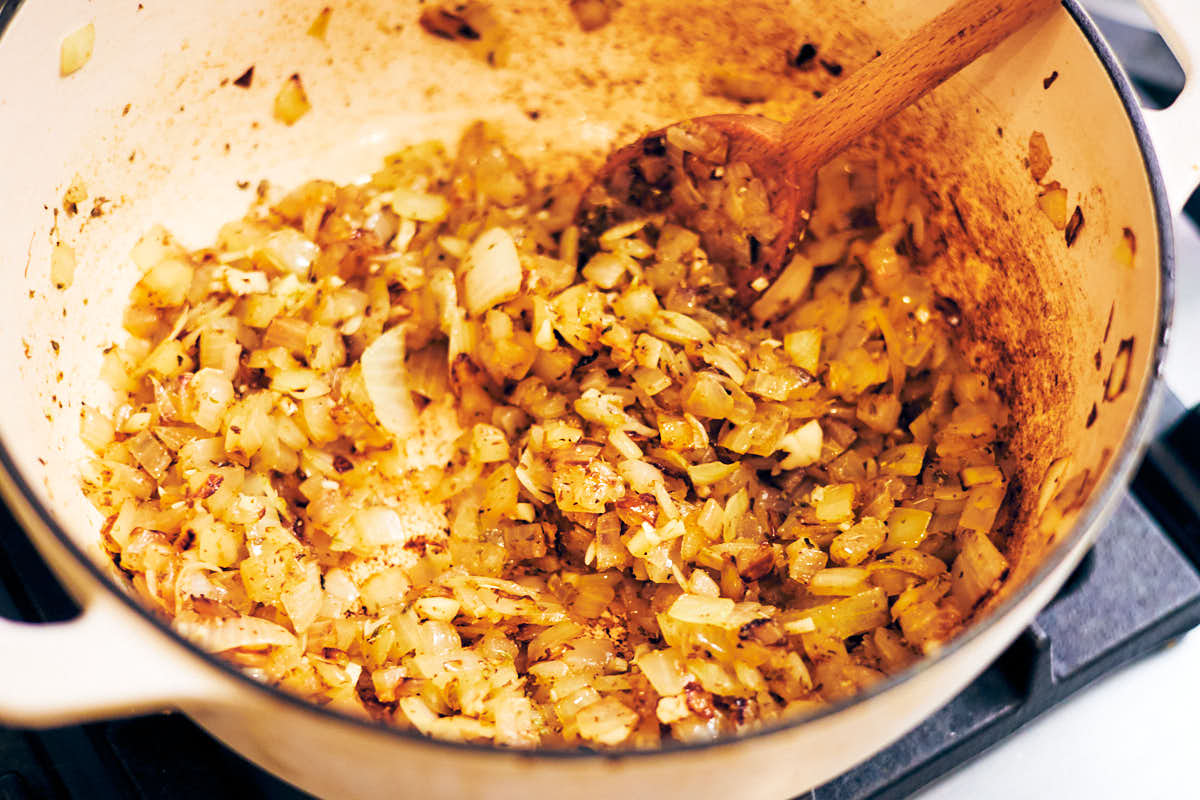 Cooking onions and spices in a pot for soup.