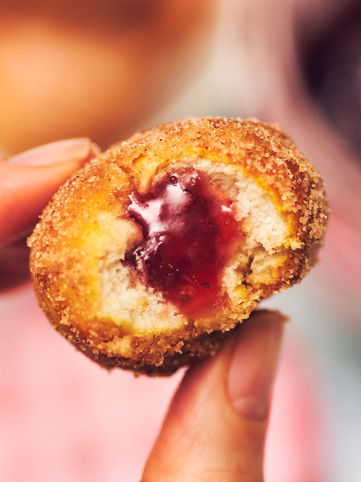 A cinnamon sugar air fried donut filled with strawberry jelly.