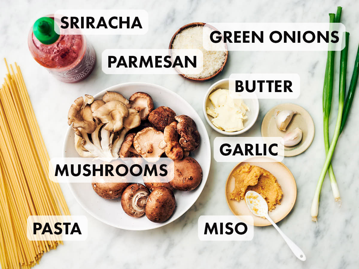 Ingredients to make miso pasta recipe including mushrooms, garlic, parmesan, green onions.