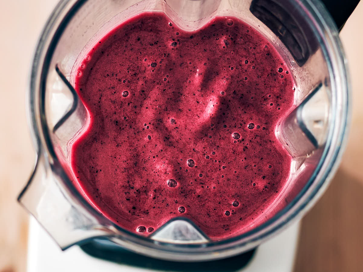 Blueberry pineapple smoothie in a blender.