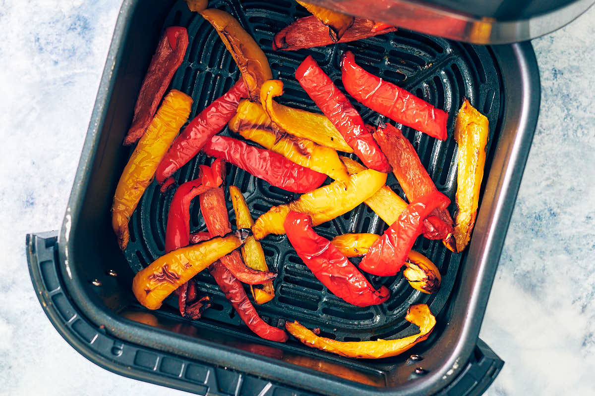 Roasted bell peppers in an air fryer basket.