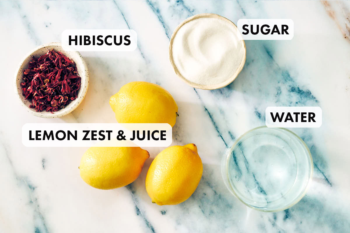 Ingredients to make Hibiscus Lemonade, including lemon zest, water, sugar.