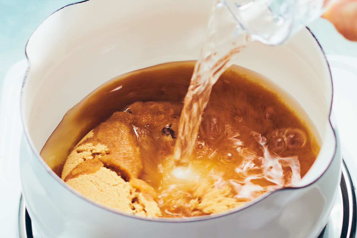 Brown sugar and water in a saucepan.