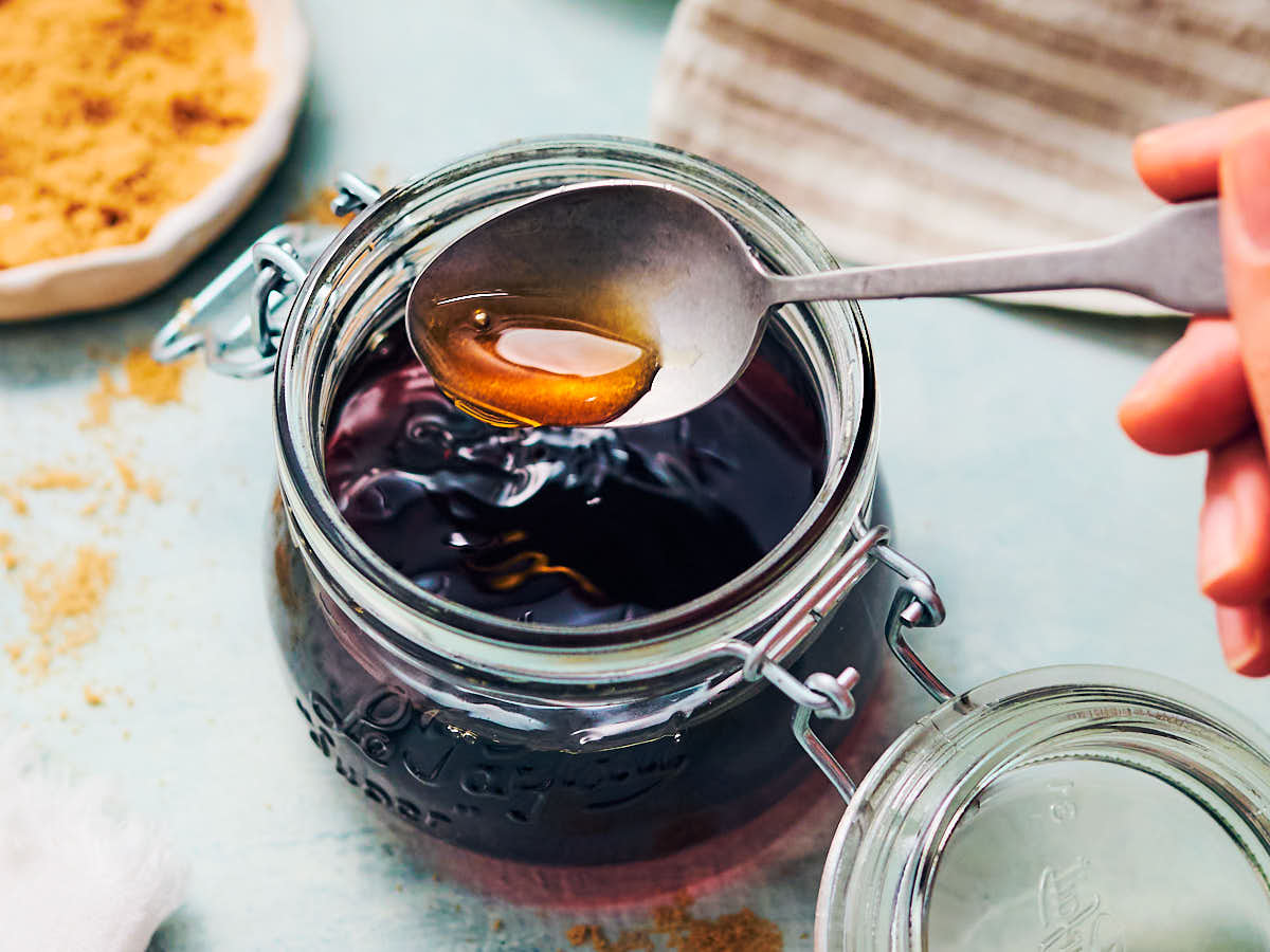 Homemade maple syrup alternative in a glass jar with spoon.