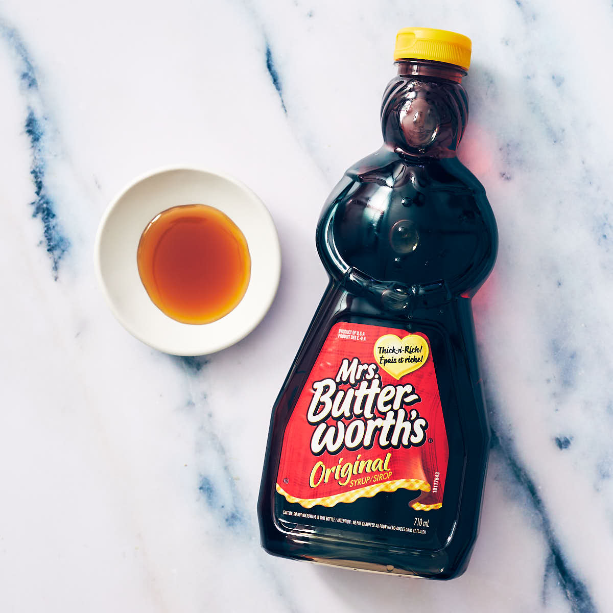 Table Syrup (Mrs. Buttersworth's brand) on a marble counter.