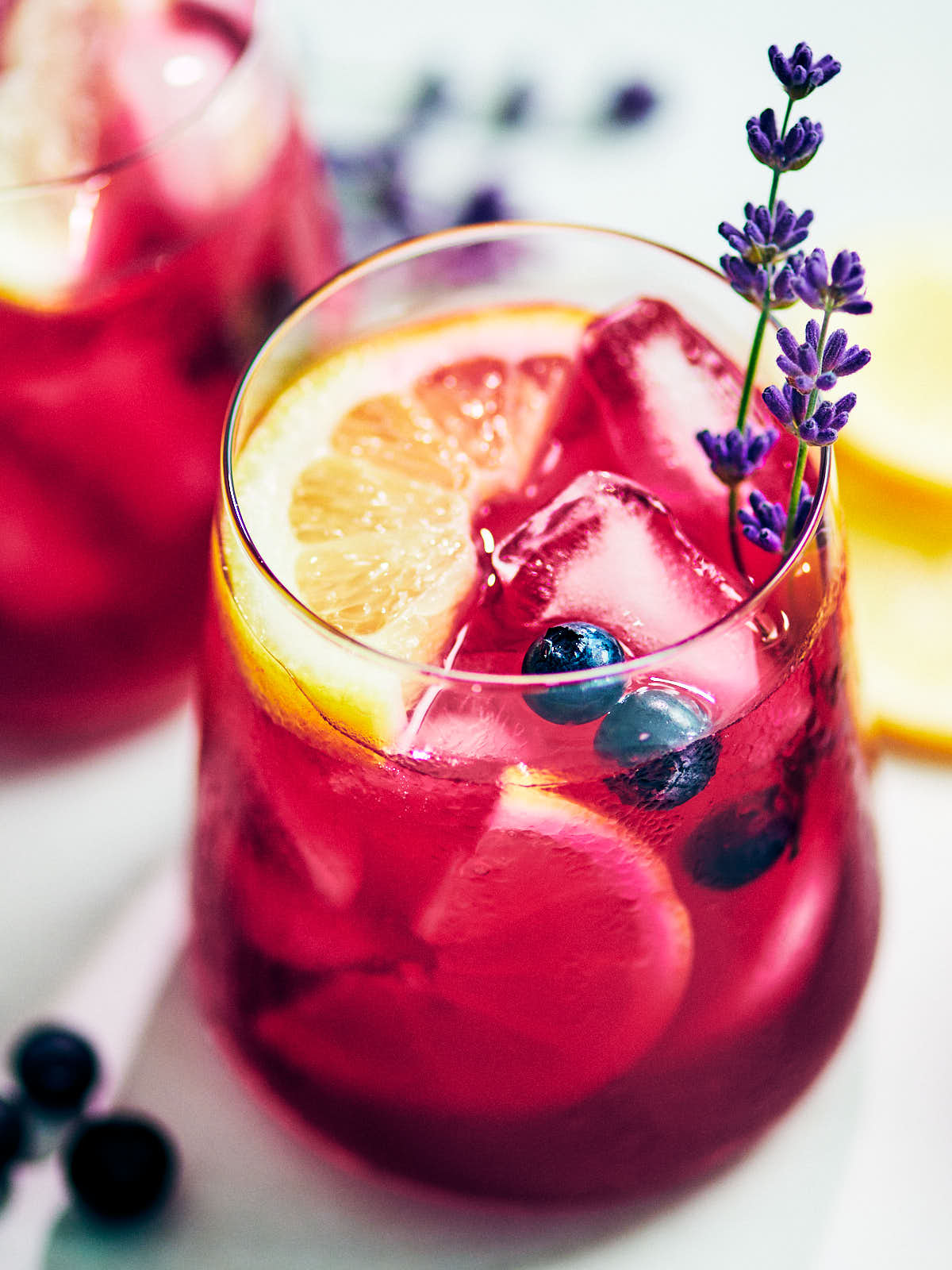 Easy Blueberry Lavender Lemonade in a glass with lemon.