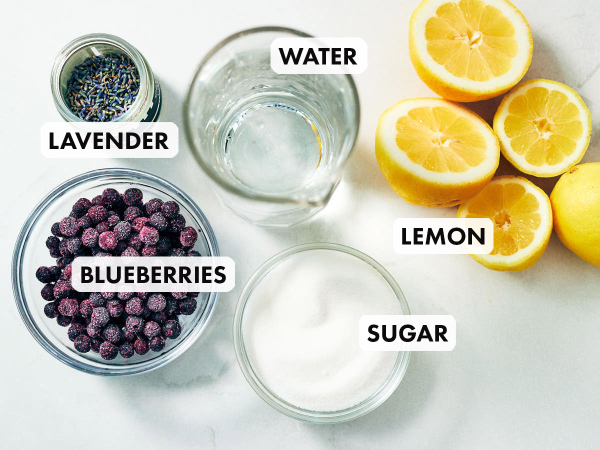 Ingredients to make blueberry lavender lemonade, including lemon, sugar, and lavender.