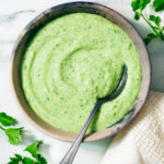 Creamy Cilantro Yogurt Sauce in a bowl with a spoon.