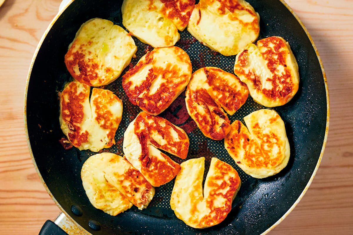 Seared halloumi cheese in a nonstick skillet pan.