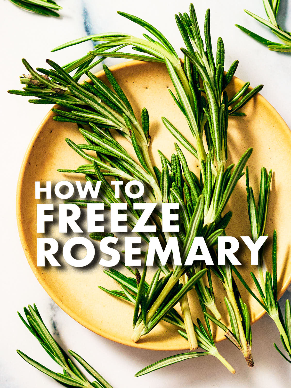 Fresh rosemary in a bowl on a kitchen counter.