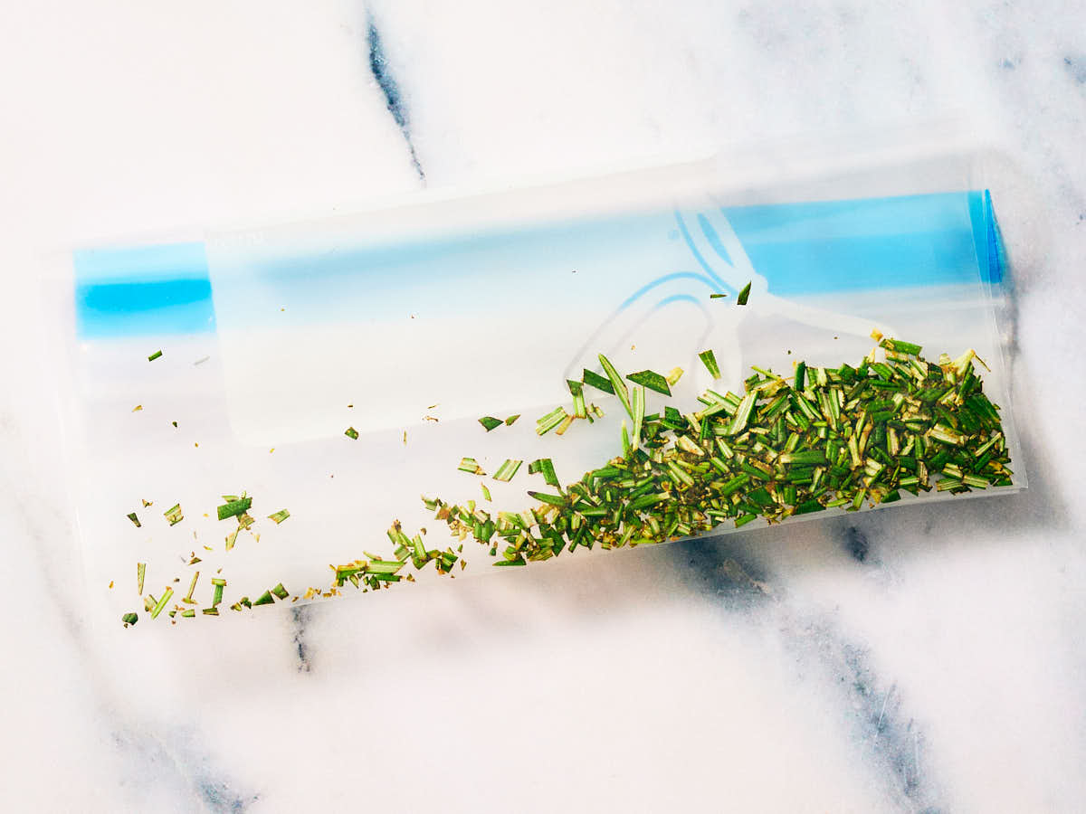 Frozen chopped rosemary in a plastic freezer bag.