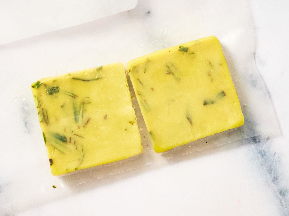 Cubes of frozen rosemary in oil in a freezer bag.