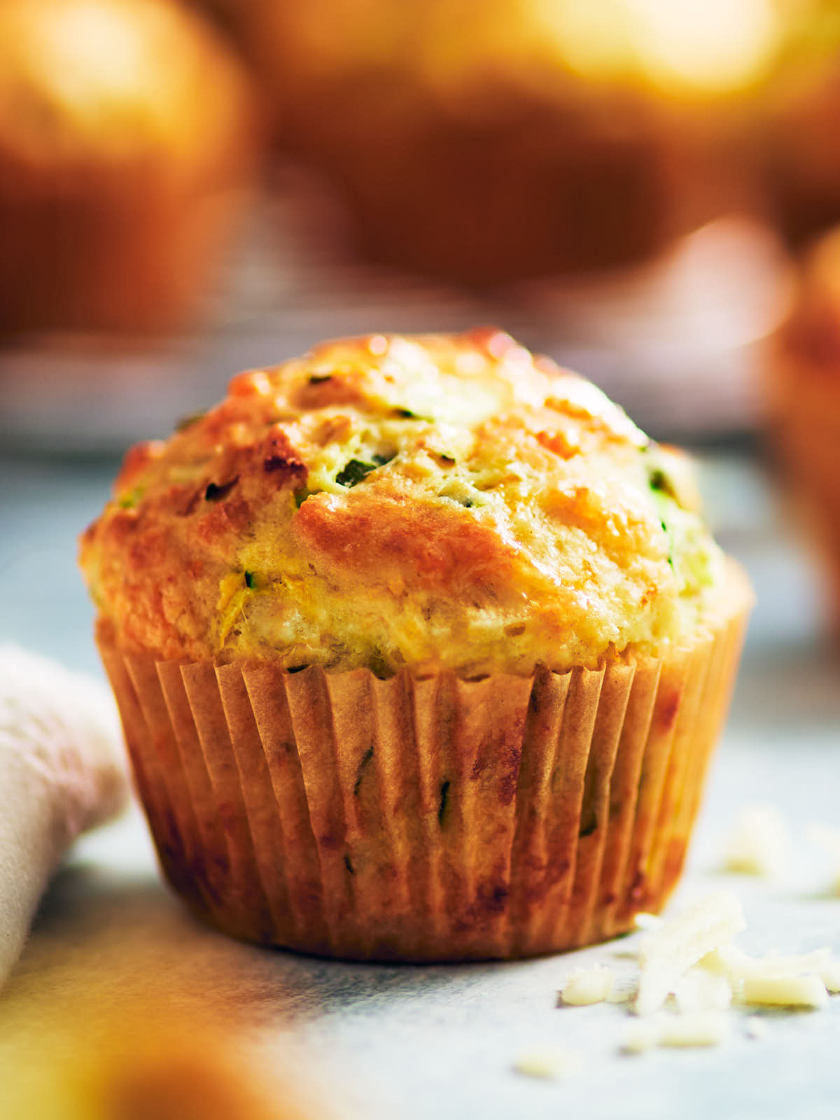 Best Savory Zucchini Muffin with cheese on a kitchen counter.