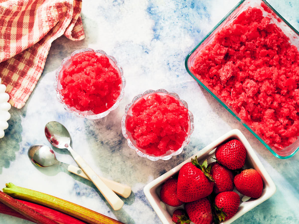 Strawberry Rhubarb Granita in serving dishes and in a glass container.