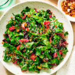 Easy Swiss Chard Salad in a bowl on a table with water glass and napkin.