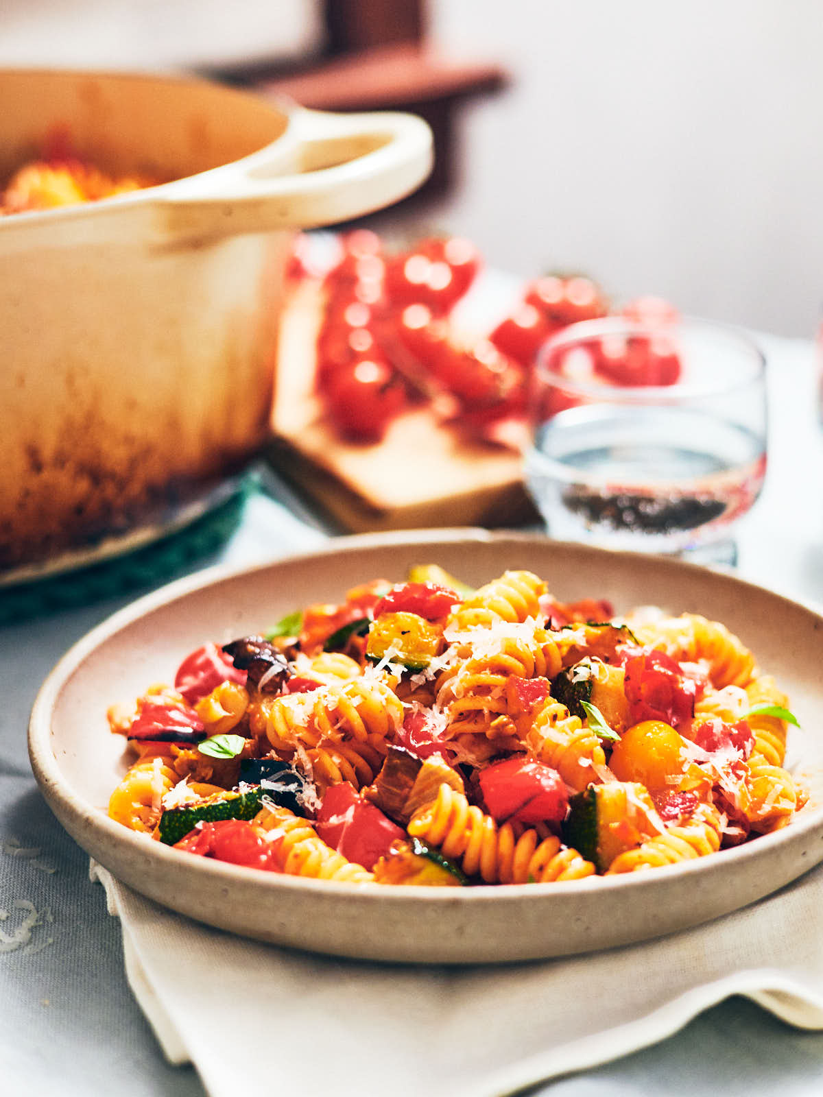 Roasted Vegetable Ratatouille Pasta in a bowl and pot on a dinner table.