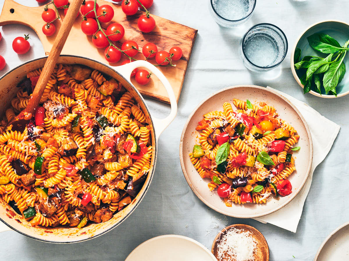 Easy vegetarian Ratatouille Pasta being served on a dinner table.