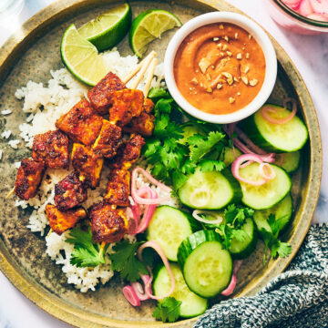 Vegan Satay Tofu Skewers with peanut sauce and quick pickled shallots.