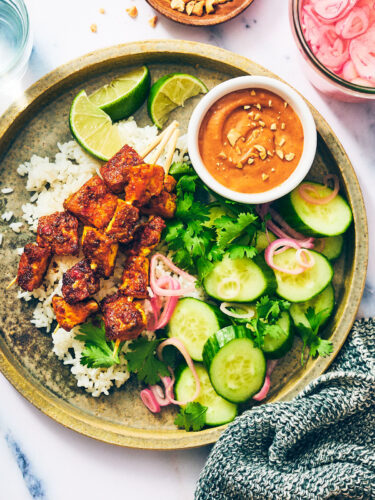 Vegan Satay Tofu Skewers with peanut sauce and quick pickled shallots.