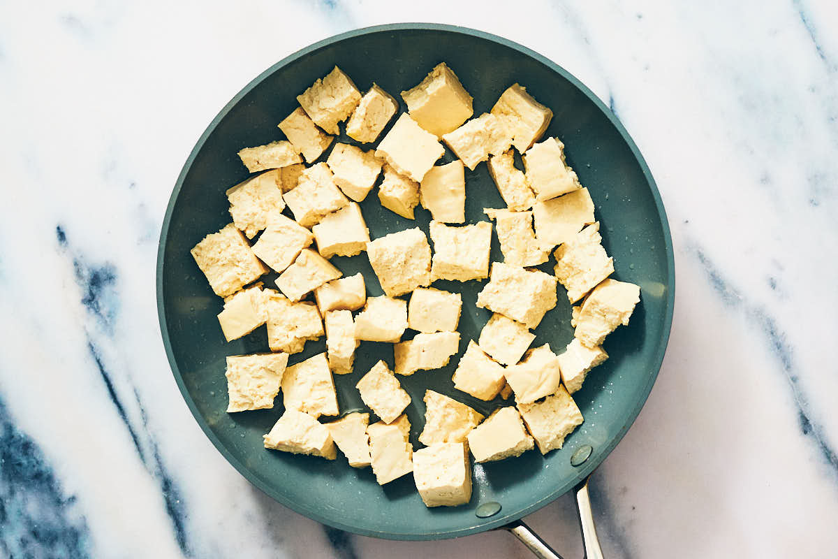 Extra firm cubed tofu in a nonstick skillet.