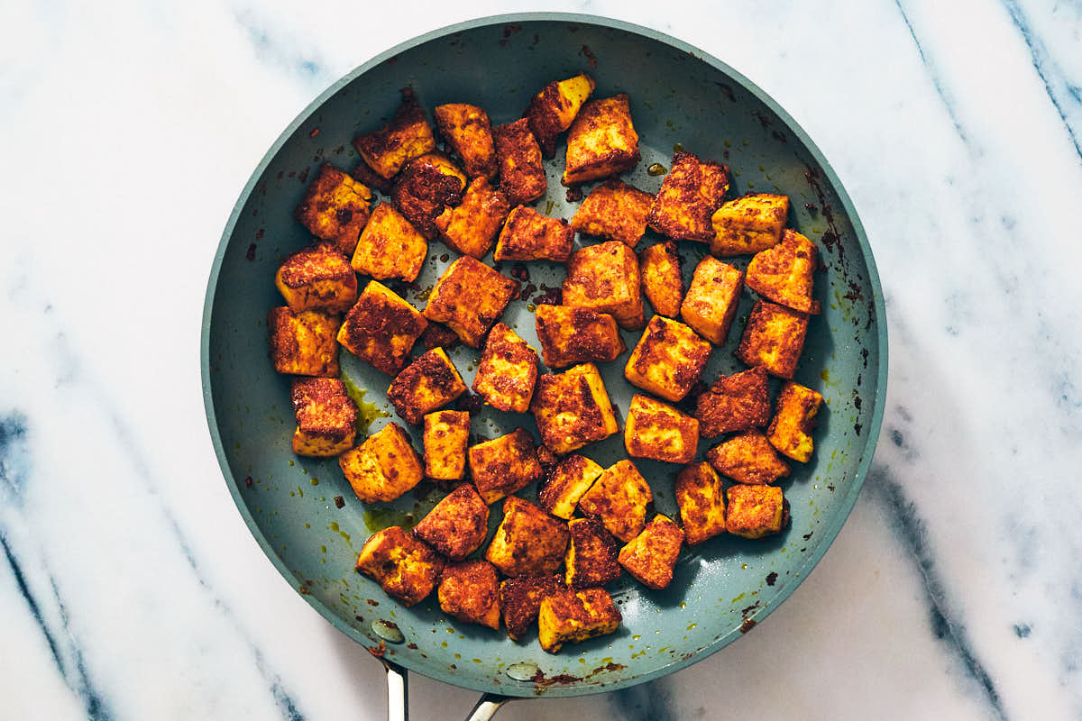 Tofu in skillet after cooking for vegan satay skewers.