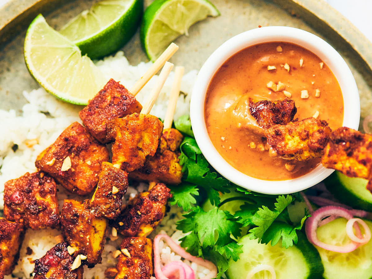 Vegan Satay Tofu Skewers with quick pickled shallots.