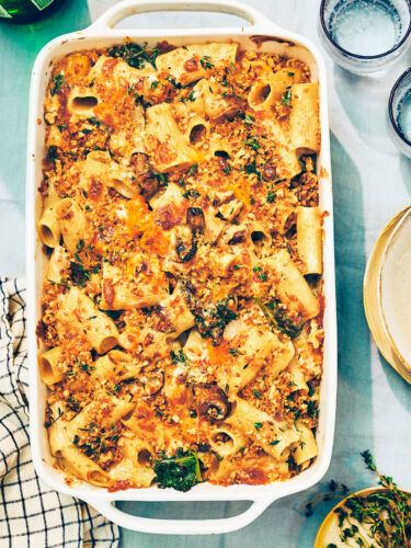 Cheesy Butternut Squash Pasta bake with kale and mushrooms in casserole dish.