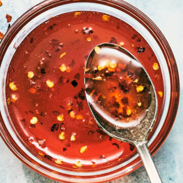 Easy homemade Hot Honey Sauce in a bowl with a spoon.