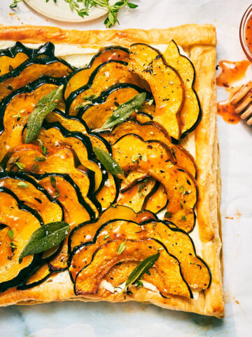 Vegetarian Roasted Squash Tart with Feta, Hot Honey, and Fried Sage.