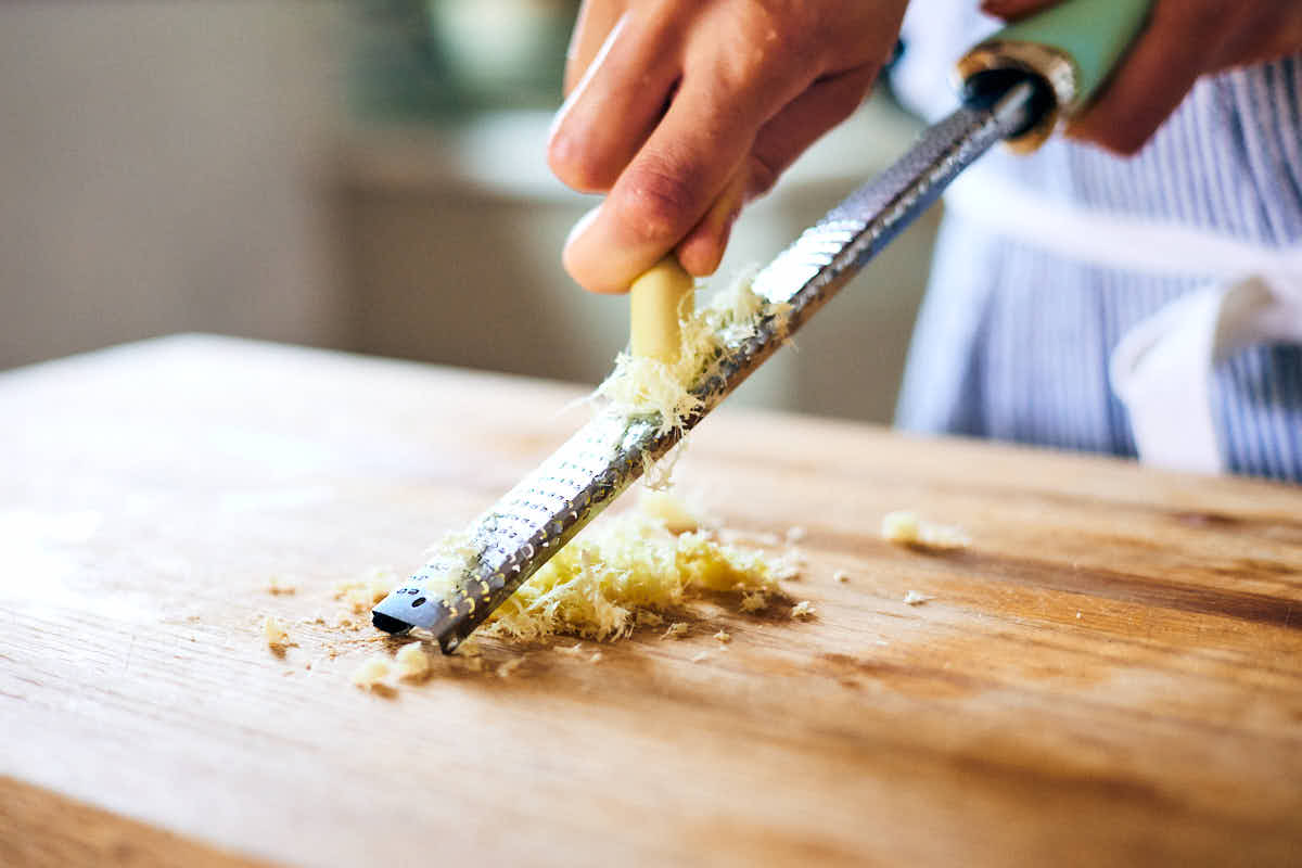 Lemongrass being finely grated on a microplane. 