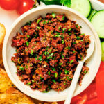 Sun Dried Tomato and Olive Tapenade in a bowl with a spoon.