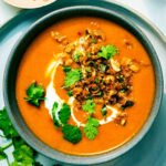 Vegan Kabocha Squash Soup with Coconut Milk in a bowl with Peanut Lime Crunch.