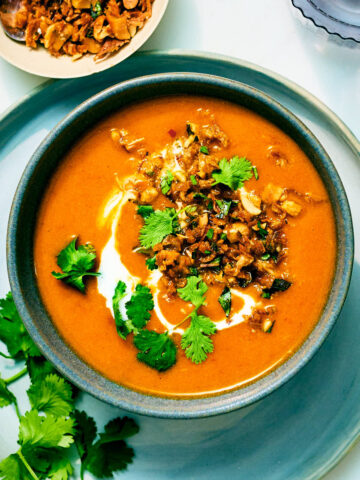 Vegan Kabocha Squash Soup with Coconut Milk in a bowl with Peanut Lime Crunch.