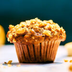 Banana Nut Bread Mini Muffin topped with chopped walnuts.