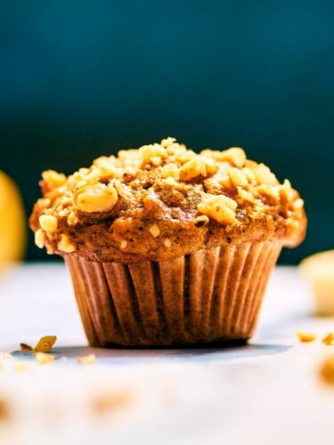 Banana Nut Bread Mini Muffin topped with chopped walnuts.