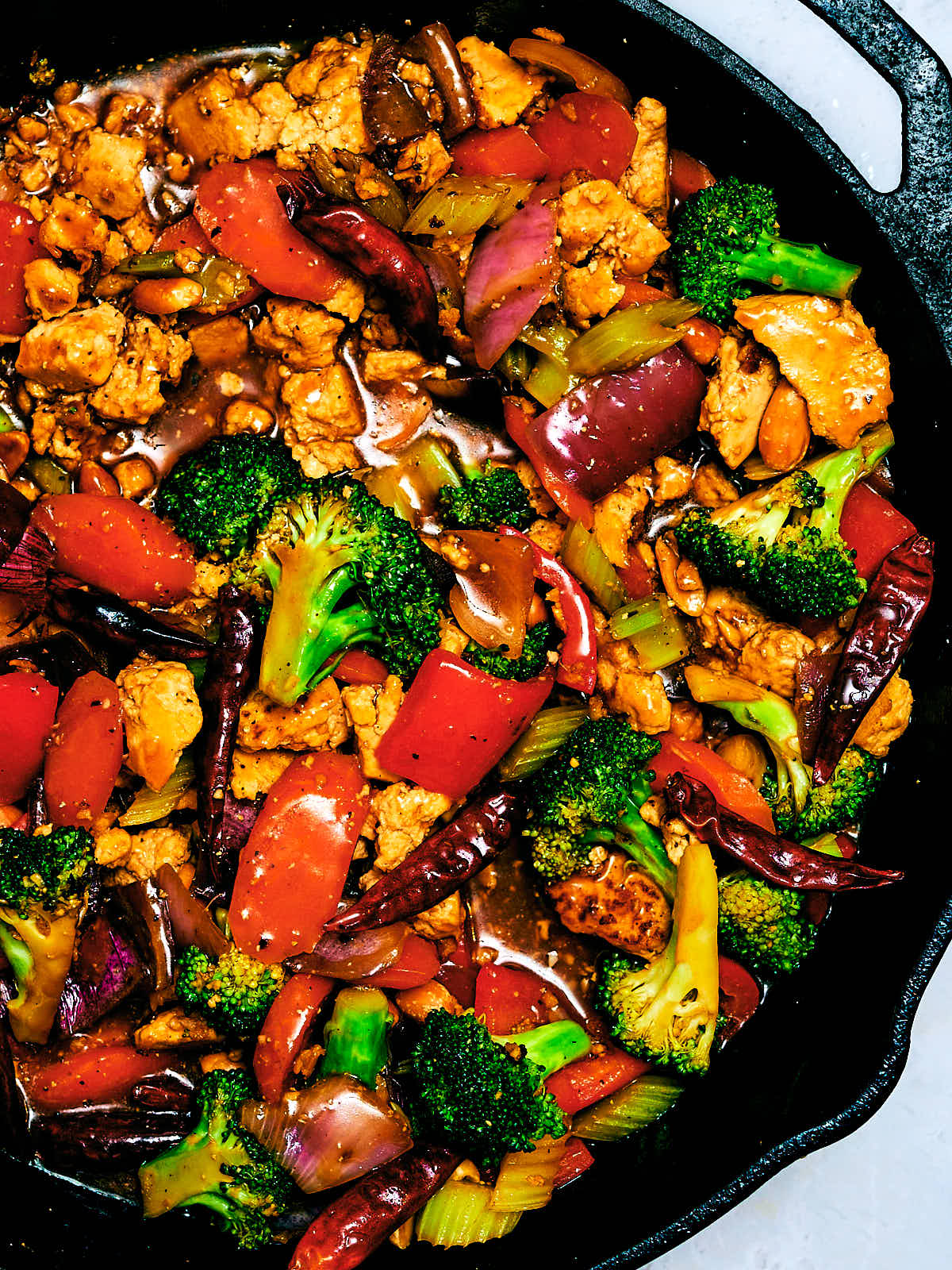 Saucy Kung Pao Vegetables with Tofu in a cast iron skillet.