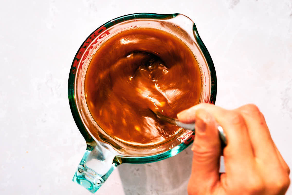 Vegan Kung Pao sauce being mixed together in a glass container.