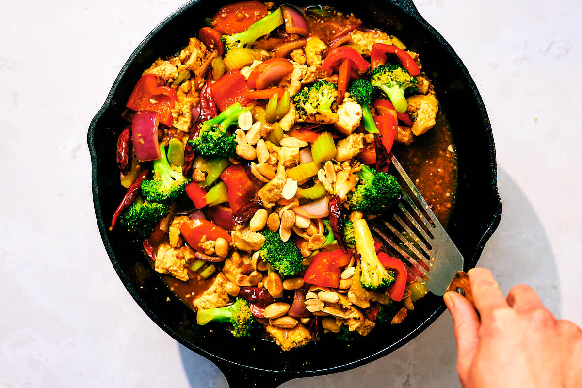Vegan Kung Pao Vegetables being sauteed in a skillet.